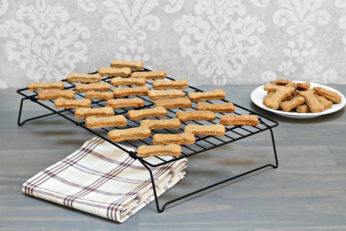 Bone-shaped dog treats on cooling rack